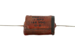 Reproduction 1954 phonebook-style capacitor. Brown wax with film condenser. 0.1 mfd, 150 VDC. 2 inch wire lead